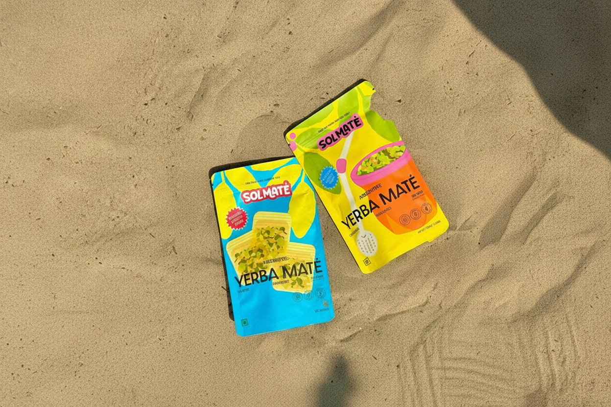 Two packages of Solmate Yerba Mate on a beach